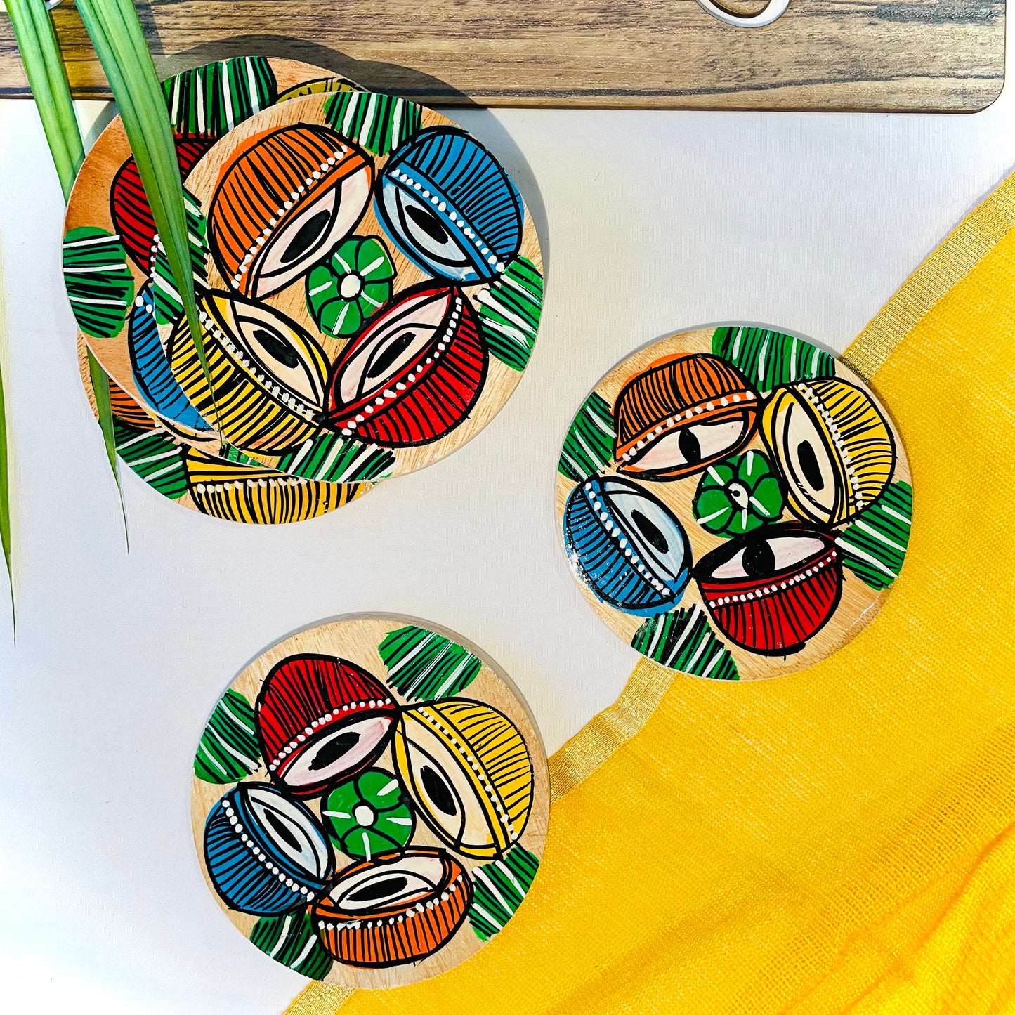 Alokya - 100% natural, Pattachitra painted terracotta coasters Round coasters: Tabla painted on the surface. Set of five.