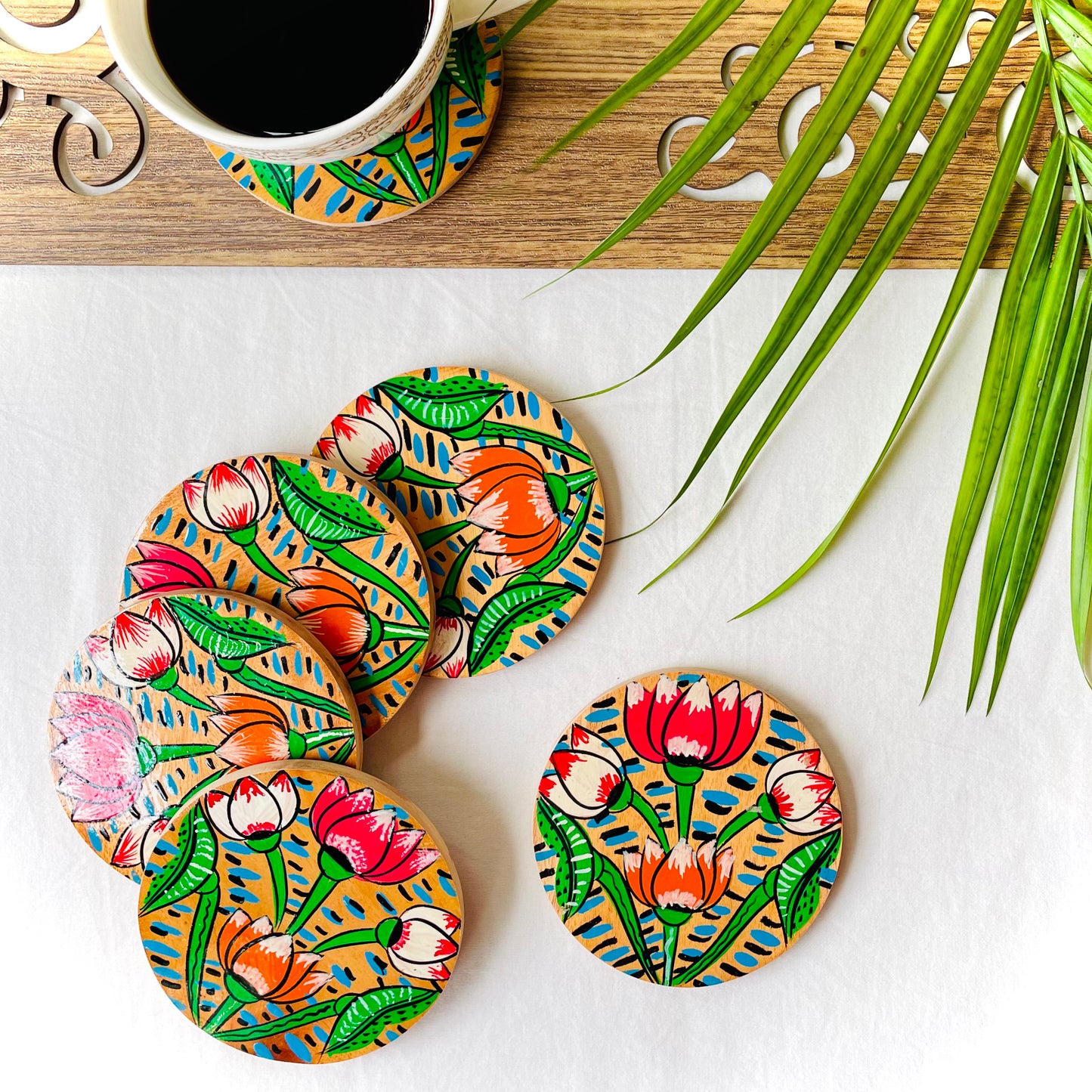Alokya - Round coasters: Lotus painted on the surface. Set of four.