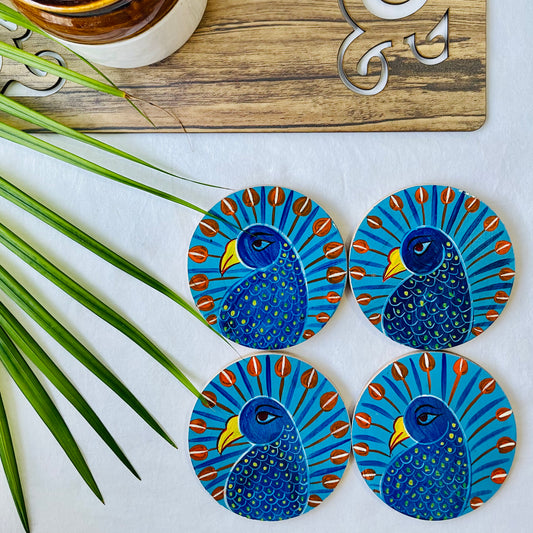 Four pure mango wood round wooden coasters, with a painting of peacocks with blue bodies, red feathers and yellow beaks