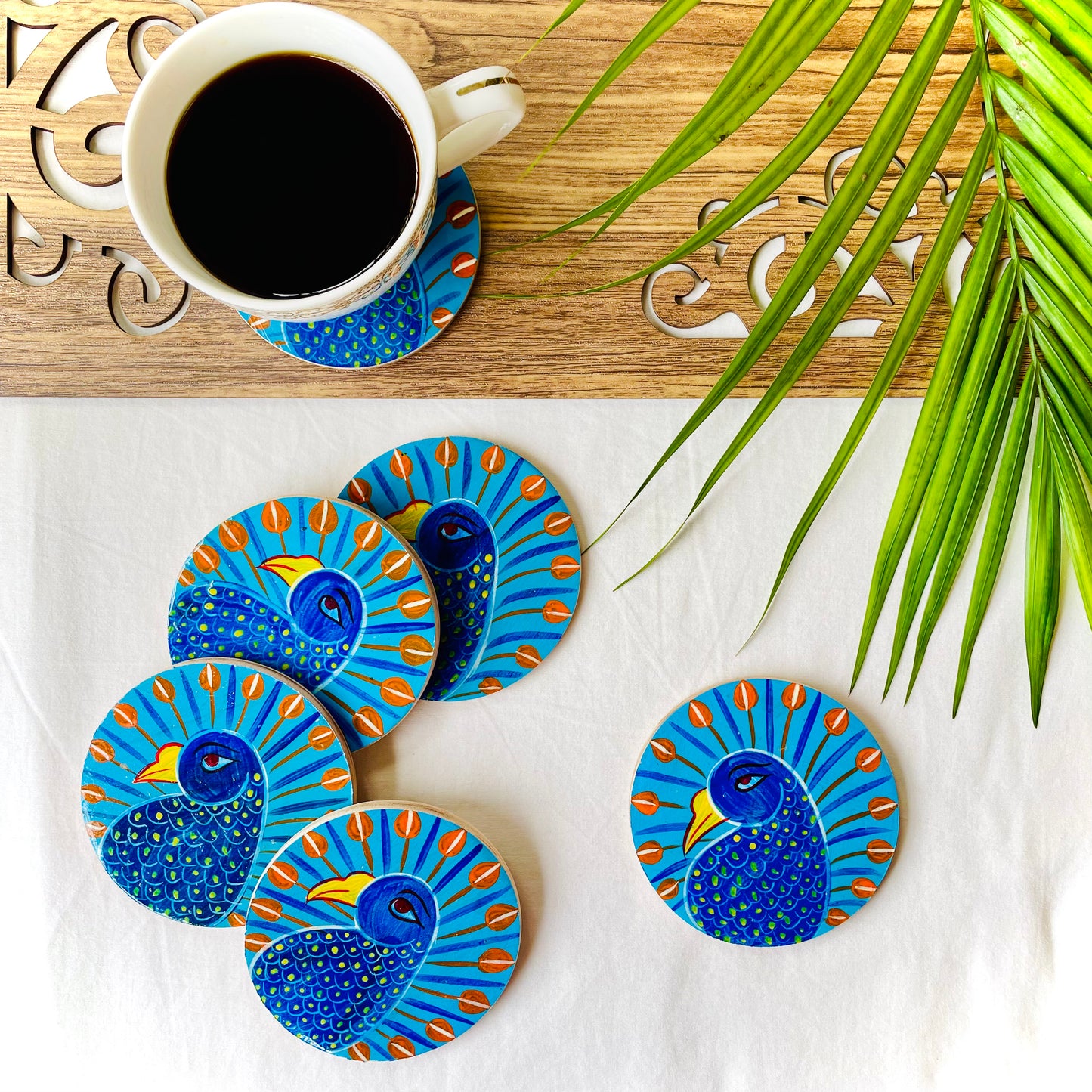 Alokya - 100% natural, Pattachitra painted terracotta coasters Round coasters: blue bird painted on the surface.