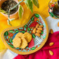 Biscuits and almonds served on a pure mango wood moon shaped wood platter/trinket tray hand-painted with three bird and tree branches motif