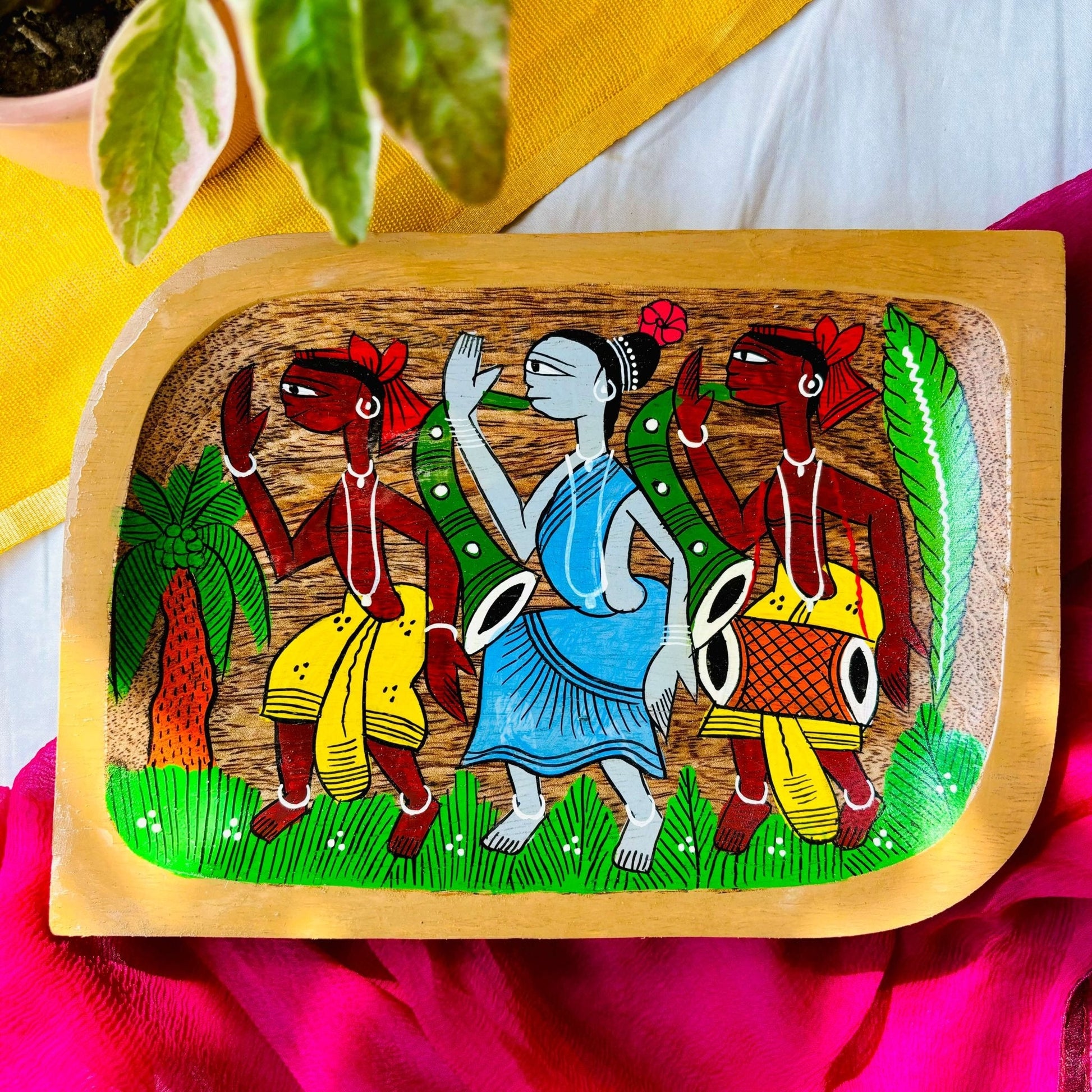 Pure mango wood square wood serving tray/trinket tray hand-painted with a motif of two tribal men wearing yellow clothes and a tribal woman wearing a blue dress dancing in a field with a coconut tree