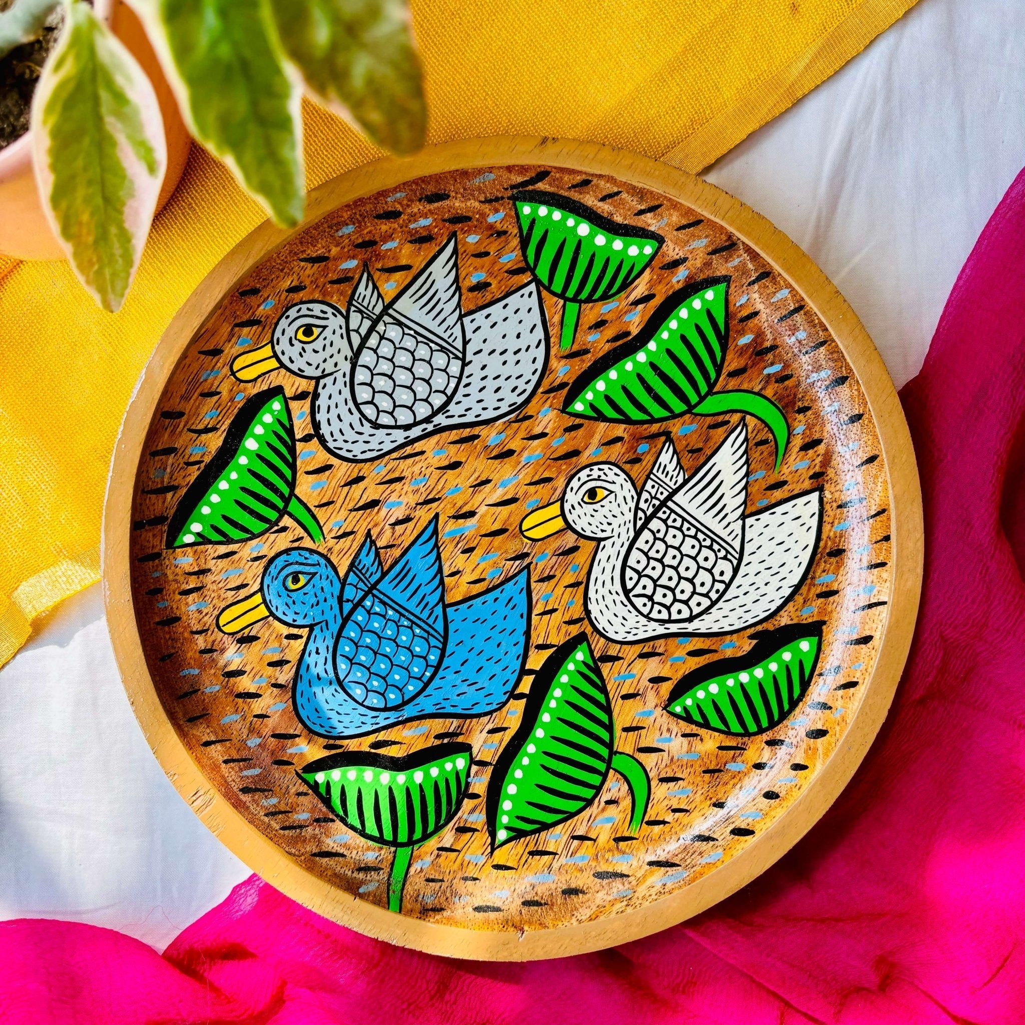 Round wooden tray or trinket tray made from locally sourced mango wood and hand-painted with three bird motifs by the generational Pattachitra artists of Pingla