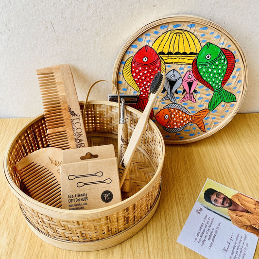 Men's neem wood beard comb, unisex neem wooden comb, cotton bamboo earbuds, tongue cleaner, bamboo toothbrush, bamboo wooden shaving razor packed in a bamboo box hand painted with fish paintings in traditional Pattachitra art form style.
