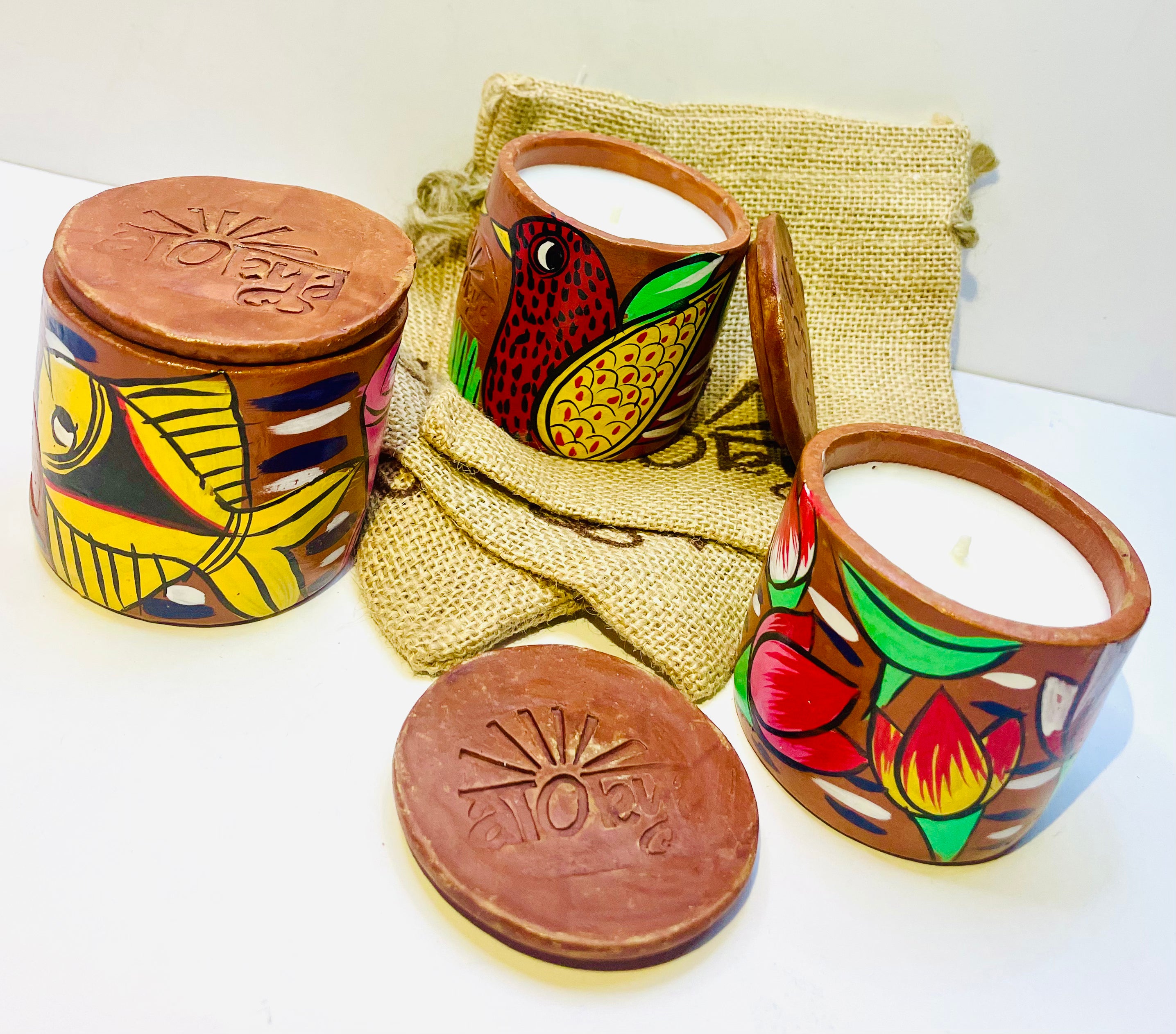 Alokya - 100% natural, soy wax scented candles handpoured in Pattachitra painted terracotta jars.