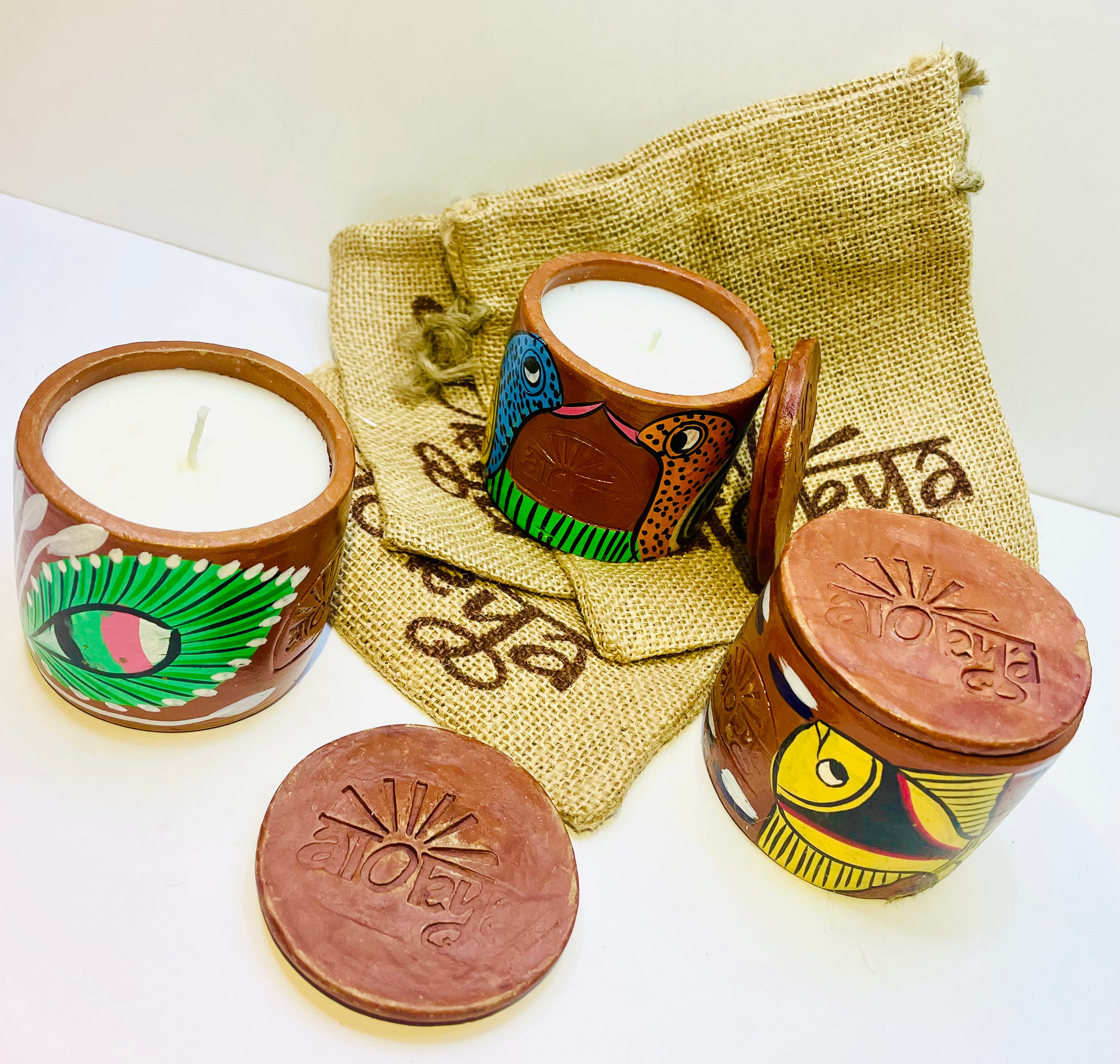 Alokya - 100% natural, soy wax scented candles handpoured in Pattachitra painted terracotta jars.