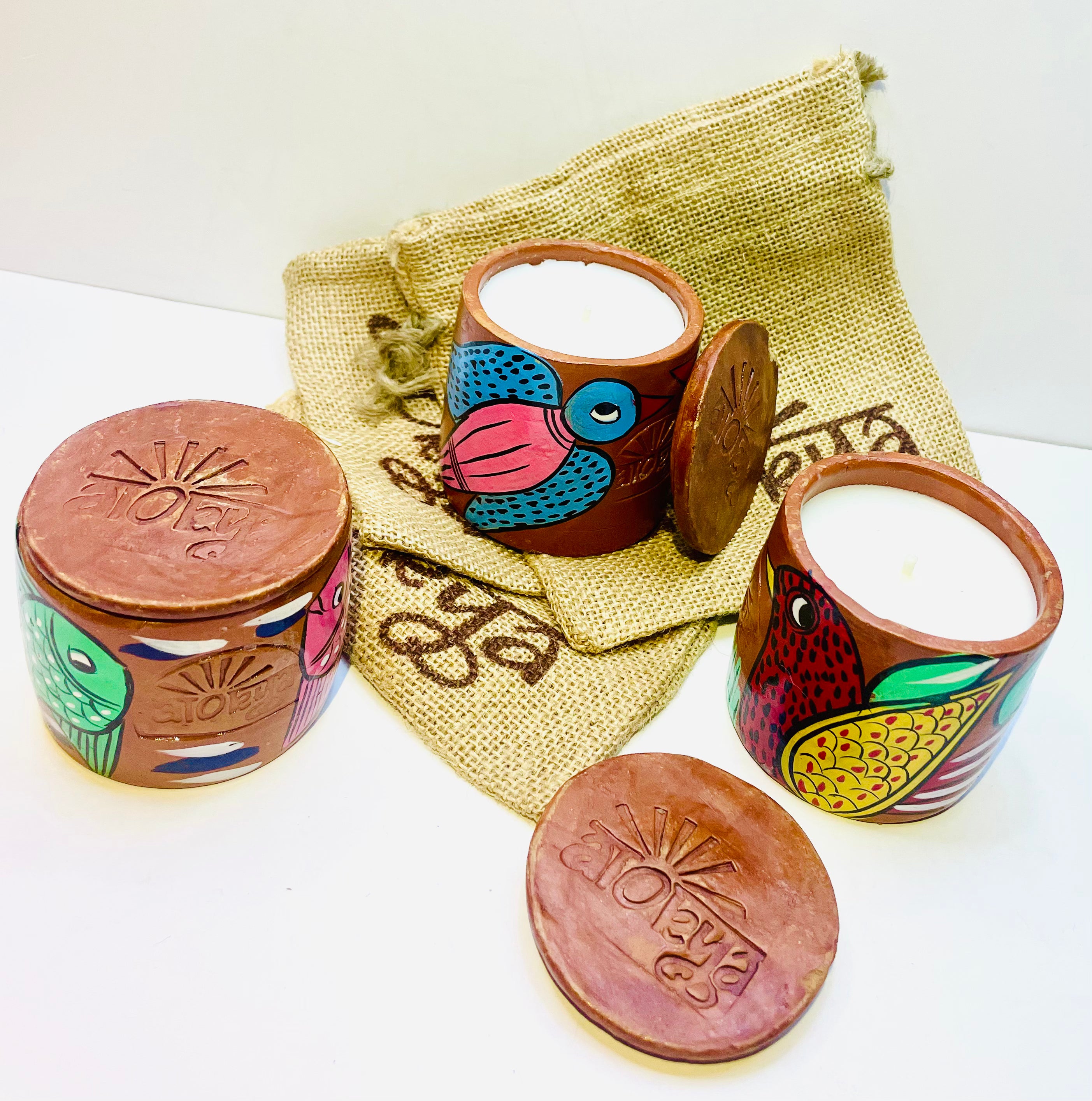 Alokya - 100% natural, soy wax scented candles handpoured in Pattachitra painted terracotta jars.